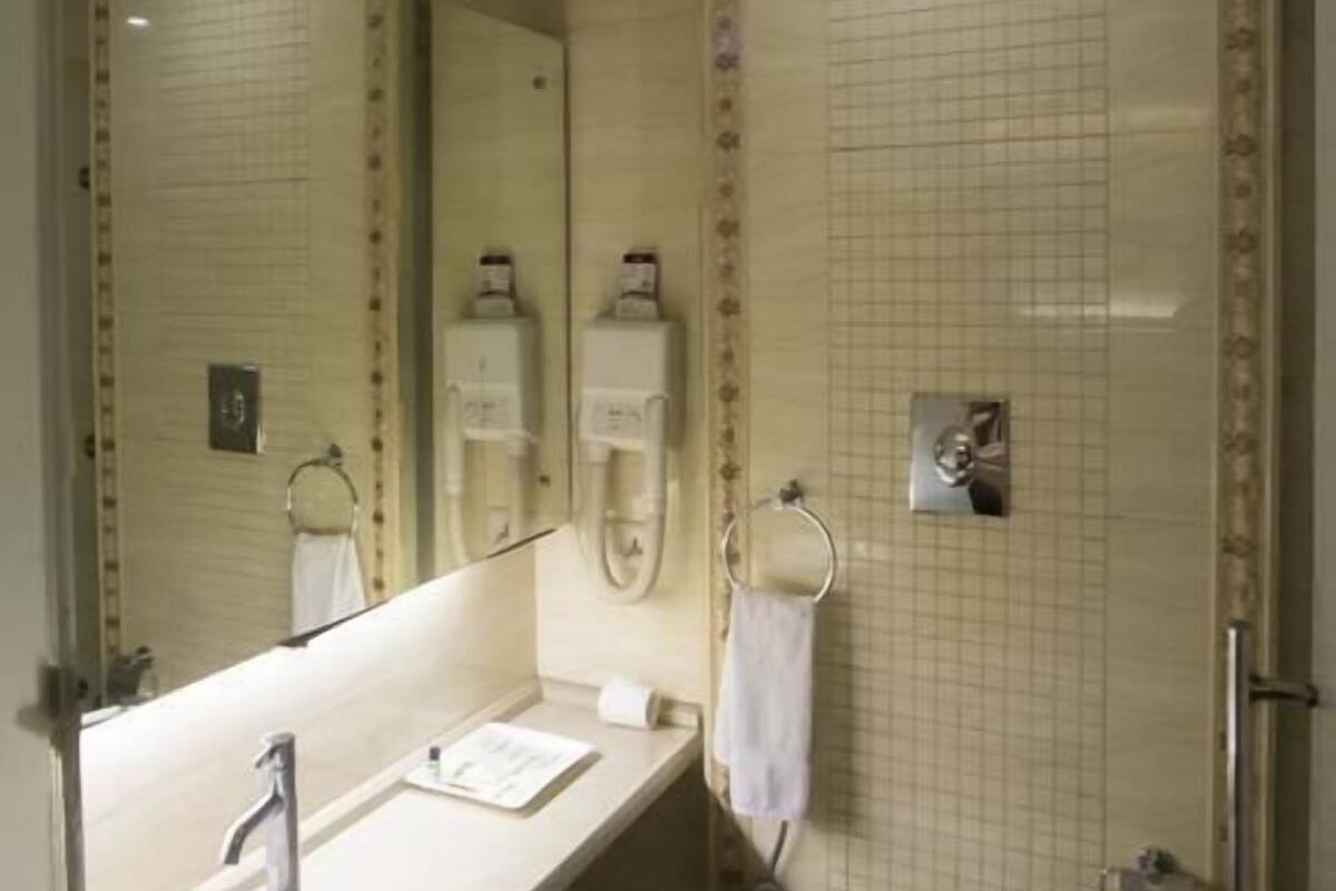 A bathroom with a sink, toilet, and shower.