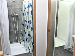 Shower, hair dryer, slippers, towels