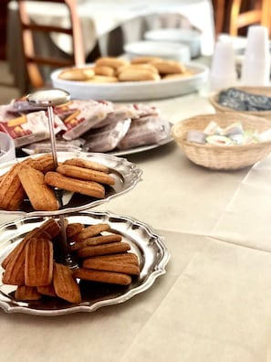 A buffet table with various food items including pastries and sandwiches. - Hotel Europa (Nocera Umbra)