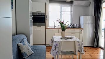Apartment (A4) | Private kitchen | Fridge, stovetop, cookware/dishes/utensils