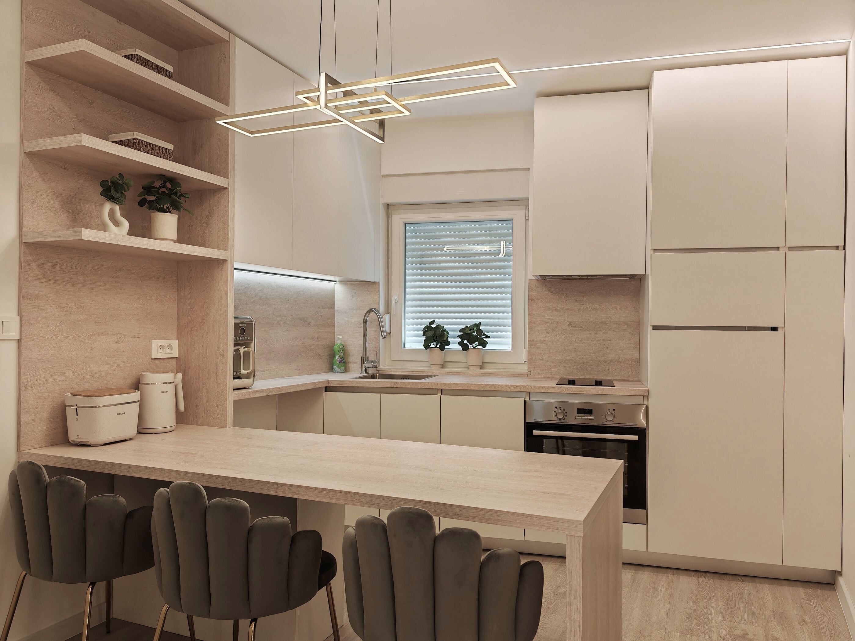 A modern kitchen with a central island, built-in appliances, and a minimalist design.