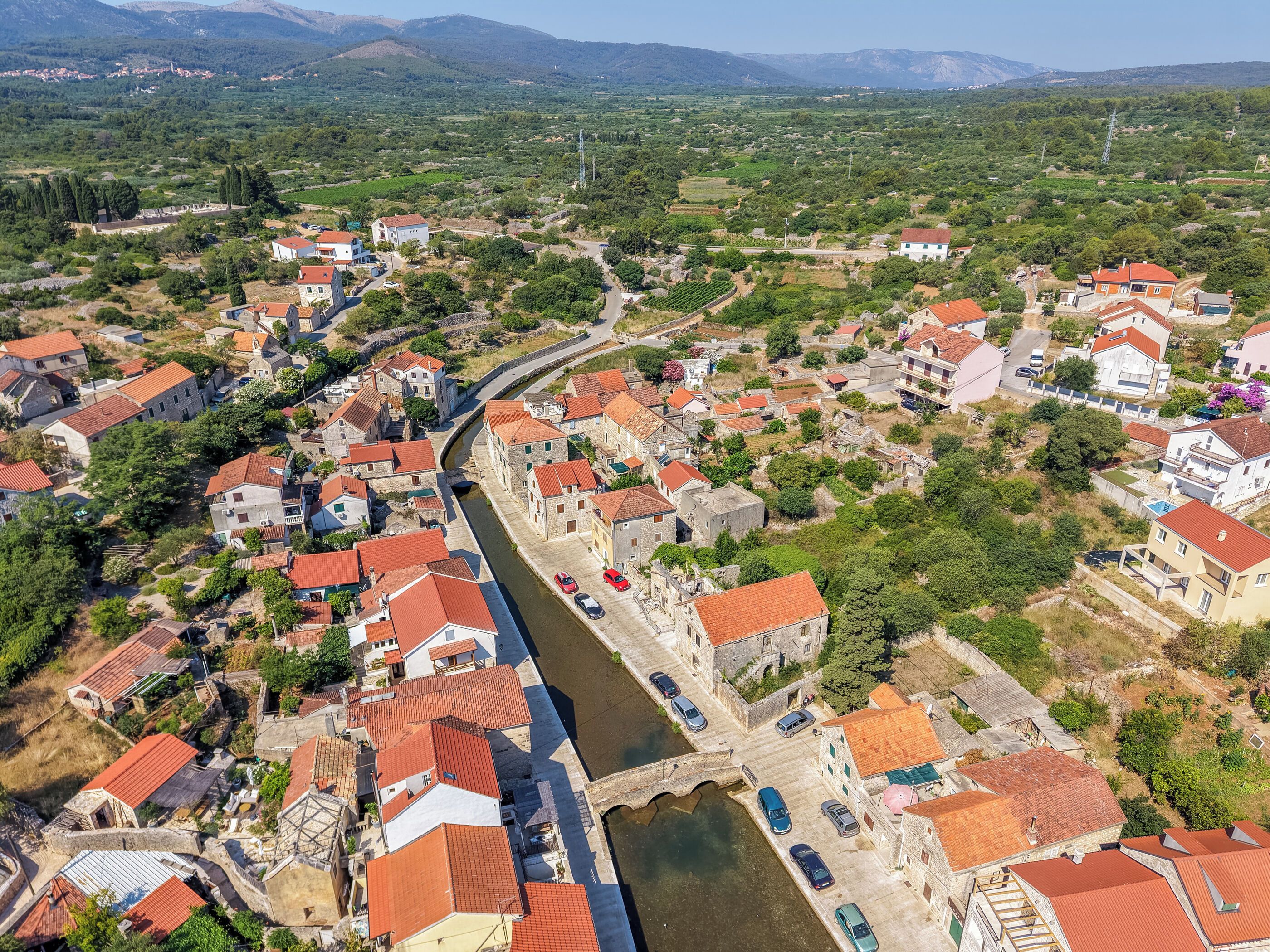 A coastal town with narrow streets, historic buildings, and a river running through the center.