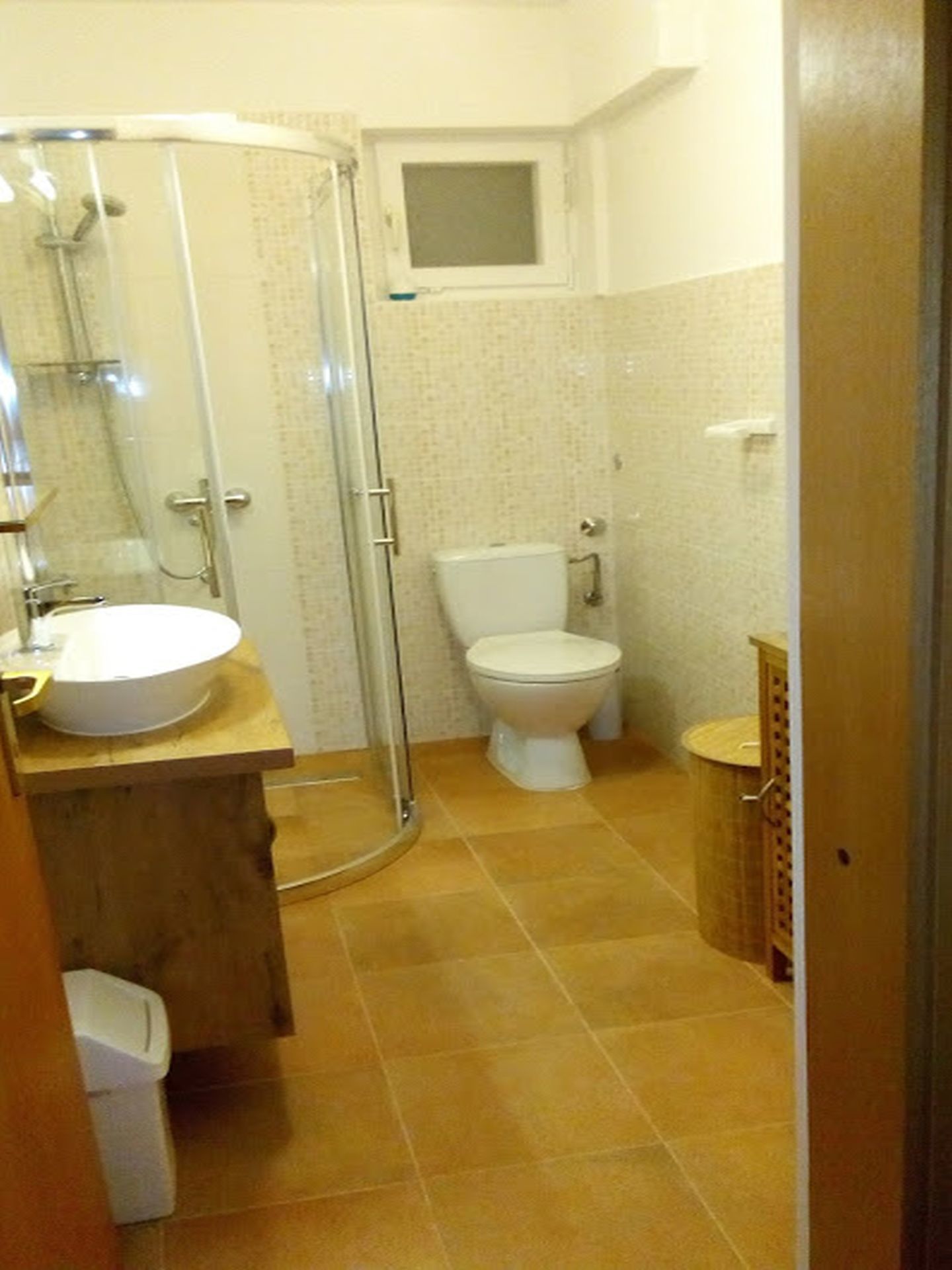 A bathroom with a shower, toilet, and sink.