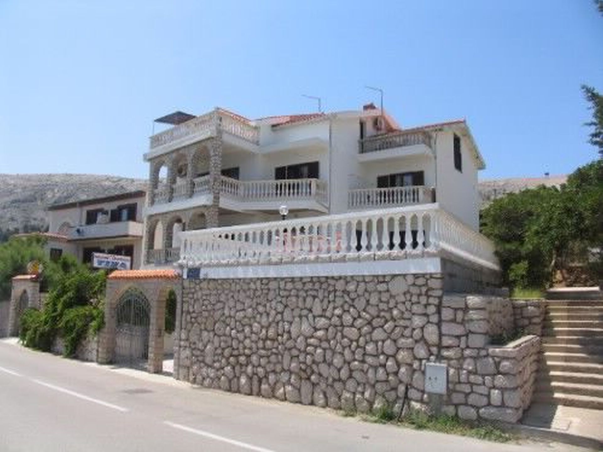 A multi-story building with a stone facade and balconies.