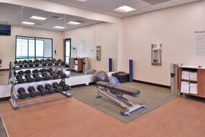 A fitness center with dumbbells, exercise balls, and a stationary bike. - Holiday Inn Express & Suites Olathe West by IHG (Olathe)