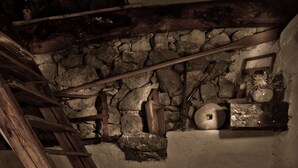 A wooden staircase leading to a stone wall with a rustic interior. - House Sandra (Stokici)