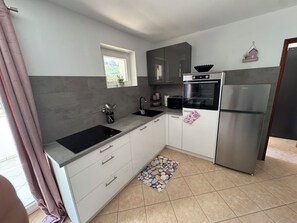 Apartment (A2) | Private kitchen | Fridge, microwave, oven, stovetop - Apartments Bruno (Baska)
