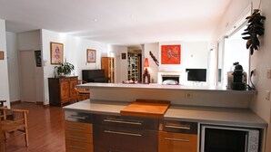 A modern kitchen with wooden cabinets, a countertop, and a built-in oven. - exceptional, quiet, golf on 27 holes character villa, heated pool (Biscarrosse)