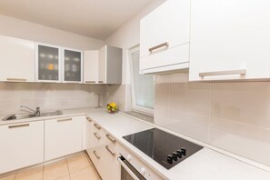 Apartamento (A2) | Cozinha privada | Geladeira, fogão, cooktop, lava-louças