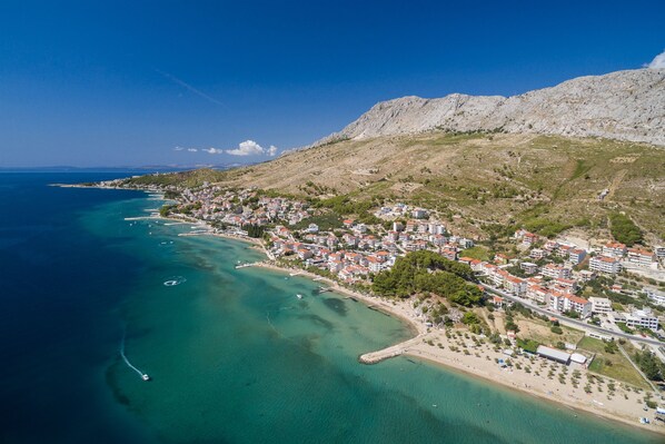 Experience the charm of a Mediterranean coastal town with its red-tiled buildings and scenic beachfront.