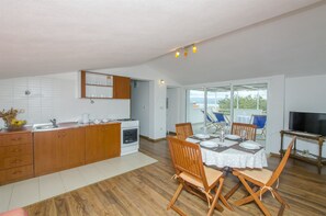 Enjoy meals in the kitchen with a dining area for four, featuring a table and chairs.