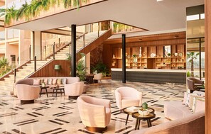 A modern lobby with a staircase, seating area, and a bar. - Zafiro Palace Andratx (Andraitx)