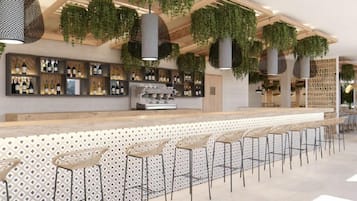 Una zona de bar con una barra alargada, diversas opciones de asientos y plantas colgantes.