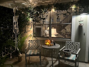 Relax in a serene outdoor setting surrounded by lush greenery and a decorative metal gate.