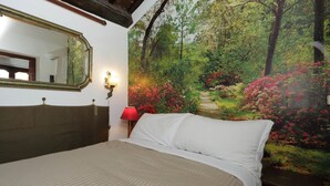 Een slaapkamer met een bed, een grote spiegel, een rode lamp en een muurschildering van een bos.
