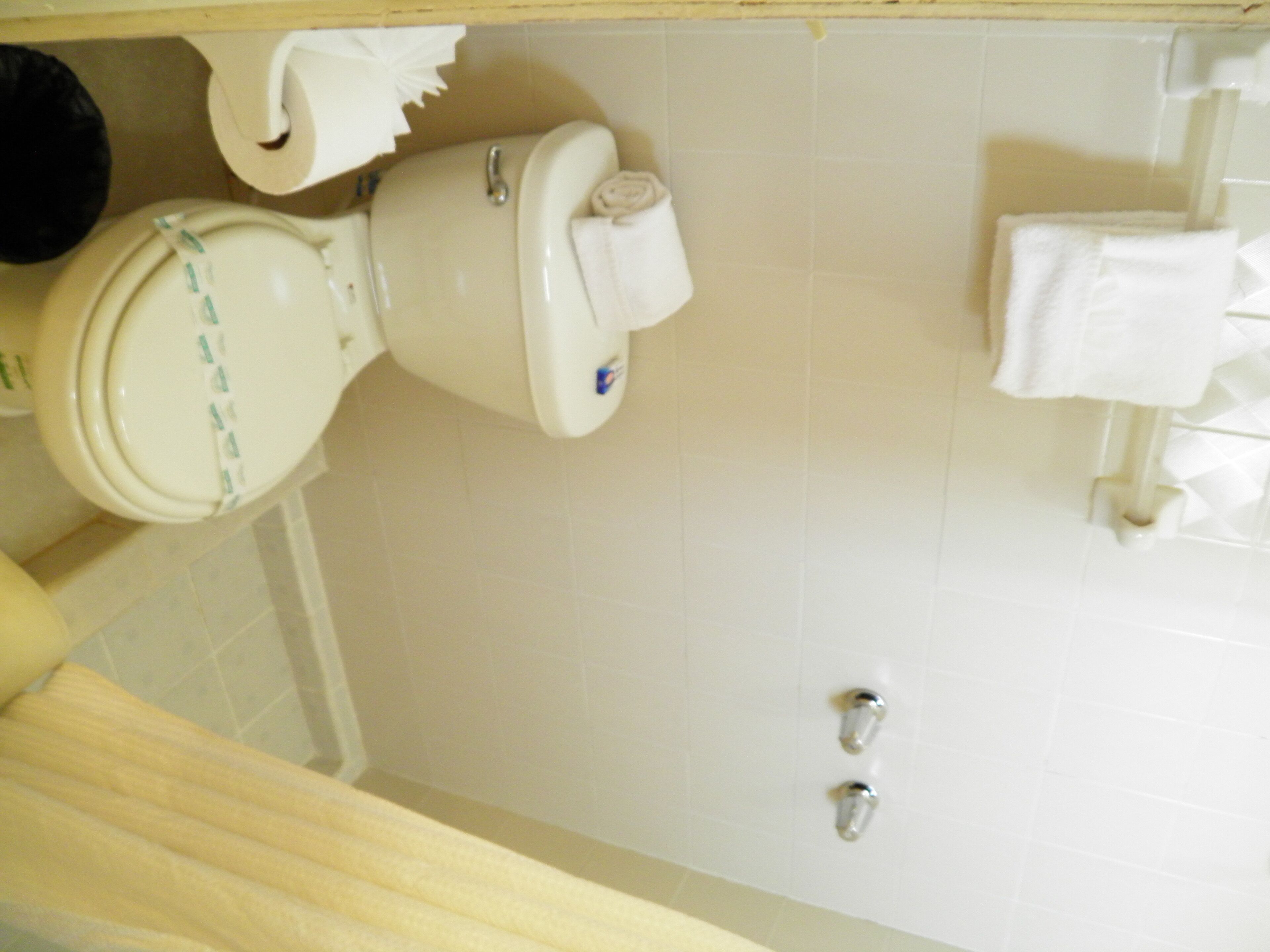 A bathroom with a toilet, a bidet, and a towel rack.