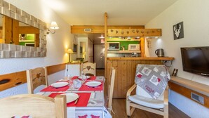A cozy kitchen with wooden cabinets, a microwave, and a kettle. - Apartment 4/5 PERS ARCS 1800 - WIFI (Arc 1800)