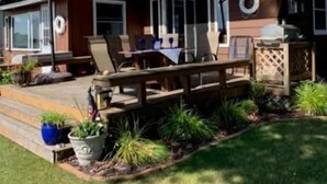 A house with a patio, outdoor seating, and a covered area.