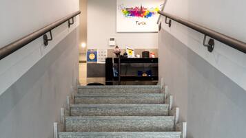 A staircase with stone steps leading to a reception area.