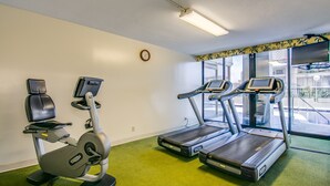 A gym with exercise equipment including a stationary bike, elliptical, and treadmills. - Pool & close to Beaches, Elegant King Bed Studio (Sleeps 4) FREE Parking! (Honolulu)