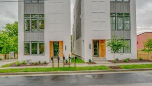 A modern two-story building with large windows and a flat roof.