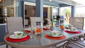 A dining table set with plates, glasses, and a decorative centerpiece.