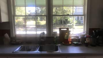 Fridge, microwave, coffee/tea maker, cookware/dishes/utensils