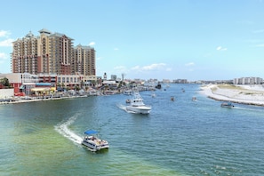 Enjoy waterfront views from the hotel's high-rise accommodations overlooking a lively marina with boats docked and in motion.