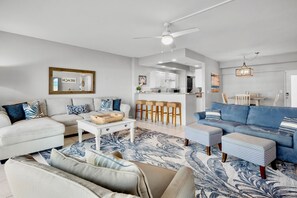 A modern living room with a sofa, a coffee table, and a patterned rug. - Private Beachfront on Siesta Key (Siesta Key)