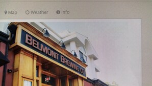 A building with a sign that reads "BELIMONT BREWERY." - Bungulow on the beach (Long beacj)