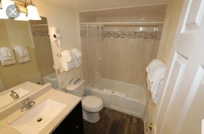 Combined shower/tub, hair dryer, towels, soap