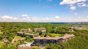 A resort with multiple buildings, a swimming pool, and surrounding greenery. - Laurel Crest (Pigeon Forge)