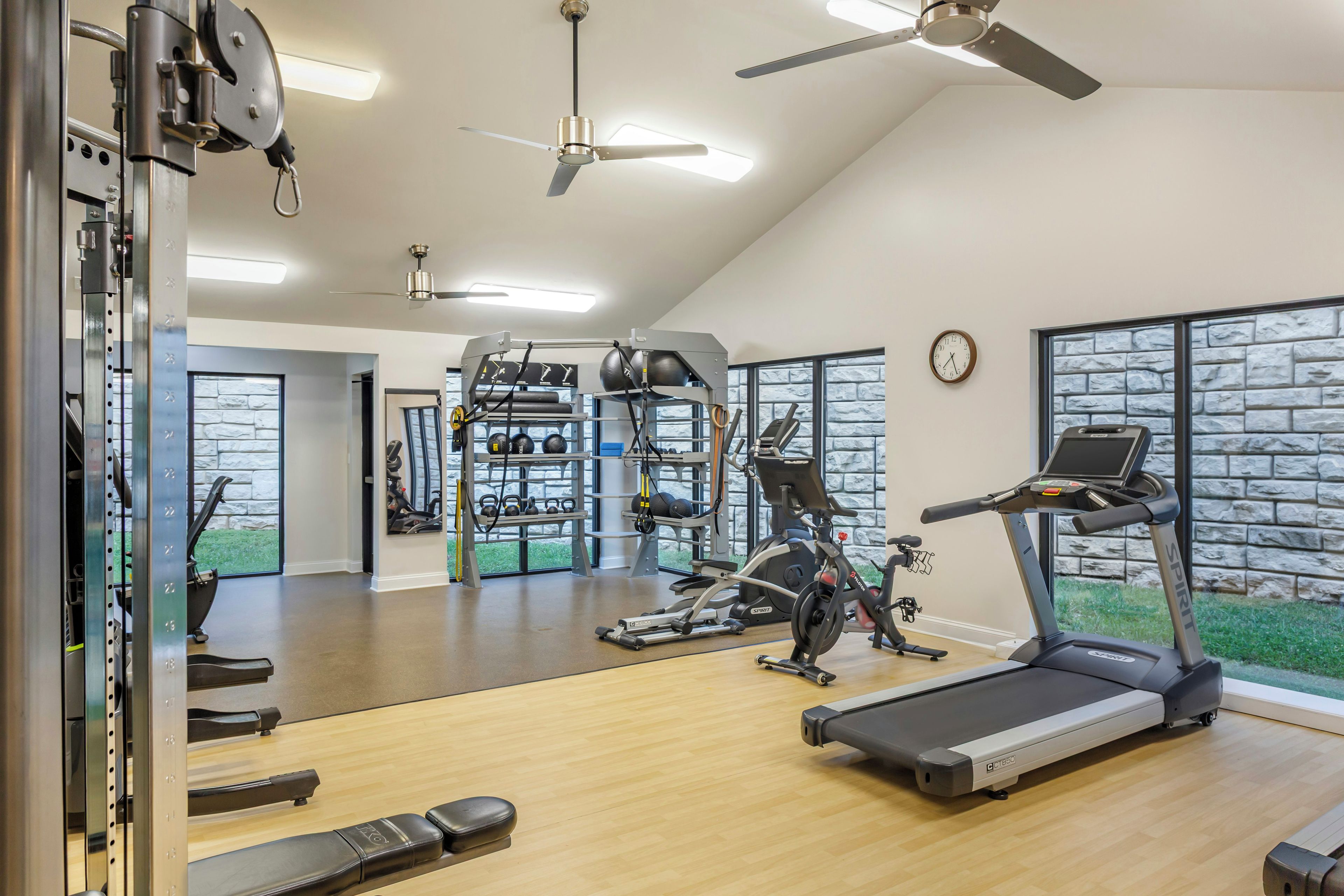 A gym with treadmills, weight machines, and free weights.