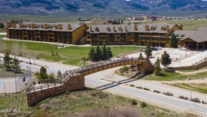 A large, multi-story building with a stone bridge leading to the entrance.