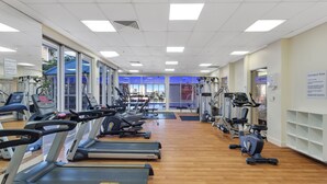 A gym with treadmills, stationary bikes, and weight machines. - Chevron Renaissance River View (Surfers Paradise)