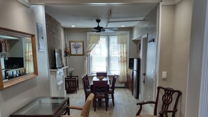 A spacious dining area with a large table and chairs, a kitchen in the background, and a patterned rug on the floor. - 2 BEDROOM 3RD FLOOR RENOVATED W/KITCHEN - 3 MINUTES TO SUBWAY (Manhattan)
