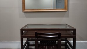 A wooden-framed mirror above a glass-top table with a wooden chair. - 2 BEDROOM 3RD FLOOR RENOVATED W/KITCHEN - 3 MINUTES TO SUBWAY (Manhattan)