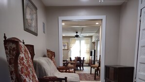 A spacious living room with a sofa, chairs, and a television. - 2 BEDROOM 3RD FLOOR RENOVATED W/KITCHEN - 3 MINUTES TO SUBWAY (Manhattan)