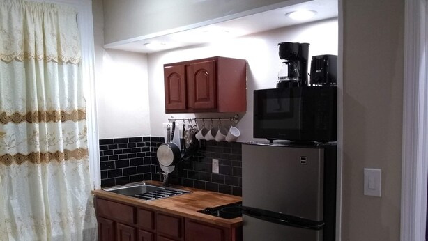 A compact kitchen with a refrigerator, microwave, and coffee maker. - 2 BEDROOM 3RD FLOOR RENOVATED W/KITCHEN - 3 MINUTES TO SUBWAY (Manhattan)