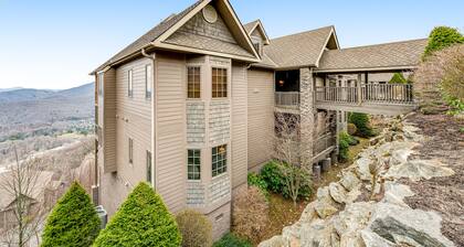 Mountain-top condo w/ endless mountain views, gourmet kitchen & stone fireplace