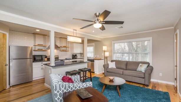 A compact living space with a kitchenette, a dining area with a coffee table, and a seating area with a sofa. - Spacious 1BR w/ KING Bed Near Hospital & Downtown (Winston-Salem)