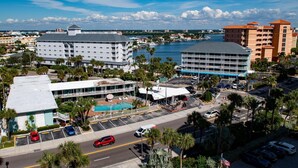 A hotel with a pool, parking, and a view of the water.