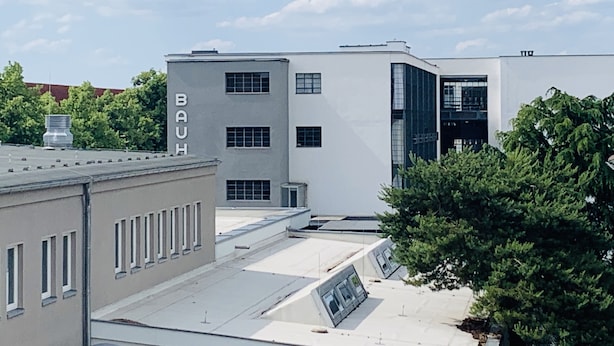 A modern building with a flat roof and a sign that reads "BAUH". - "FeWo Tante Ju" with a view of the Bauhaus in Dessau-Roßlau (Dessau-Roßlau)