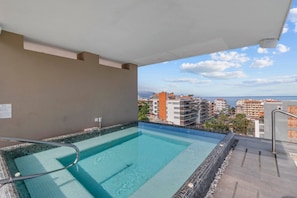 A rooftop swimming pool with a clear view of the cityscape and ocean. - Stylish Loft | Workspace, Rooftop Bar & Gym (Puerto Vallarta)