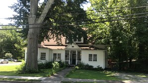 A two-story house with a front porch, a driveway, and a lawn. - The Zen-ter BNB Suite #1 in the Heart of Carrollton Georgia (Carrollton)