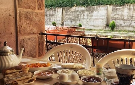 A table set with various dishes, a teapot, and a cup, likely for a meal.