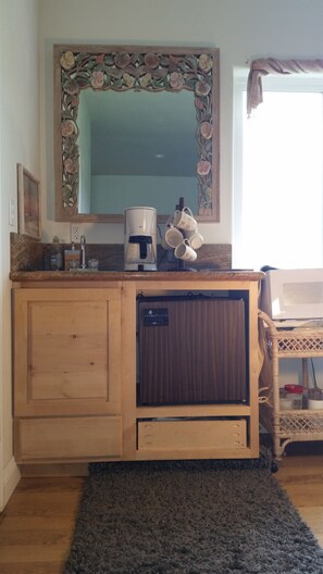 Relax in this inviting room with a vanity, mirror, and comfortable seating area.