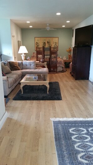 Relax in this inviting living space with a comfortable sofa, coffee table, and a beautiful painting on the wall.