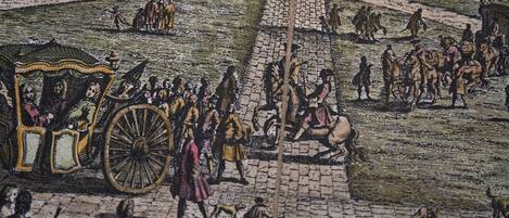 A detailed street scene with cobblestone pavement, horse-drawn carriages, and pedestrians.