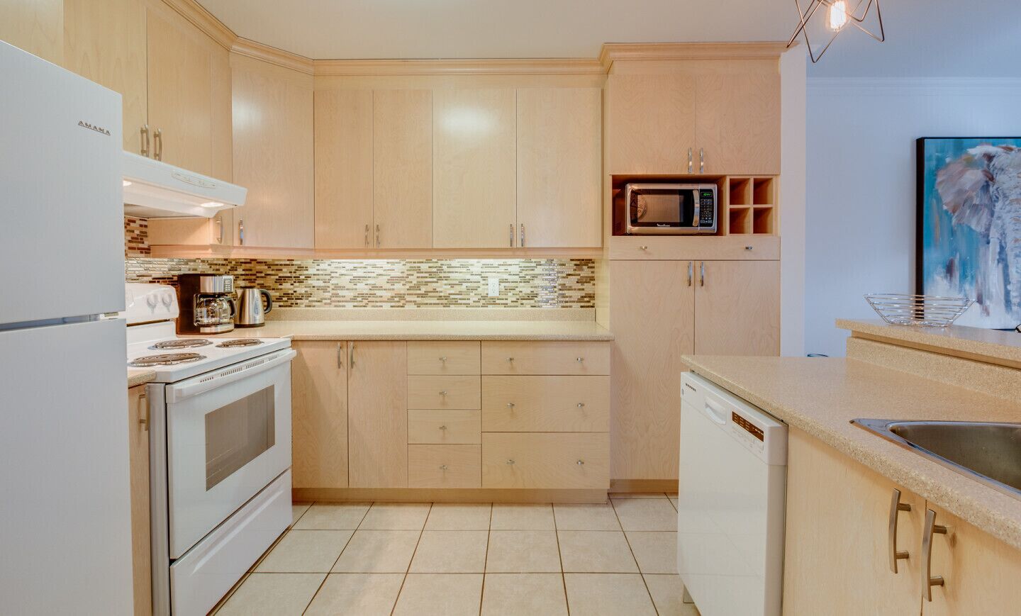 A modern kitchen with wooden cabinets, a built-in microwave, and a dishwasher.